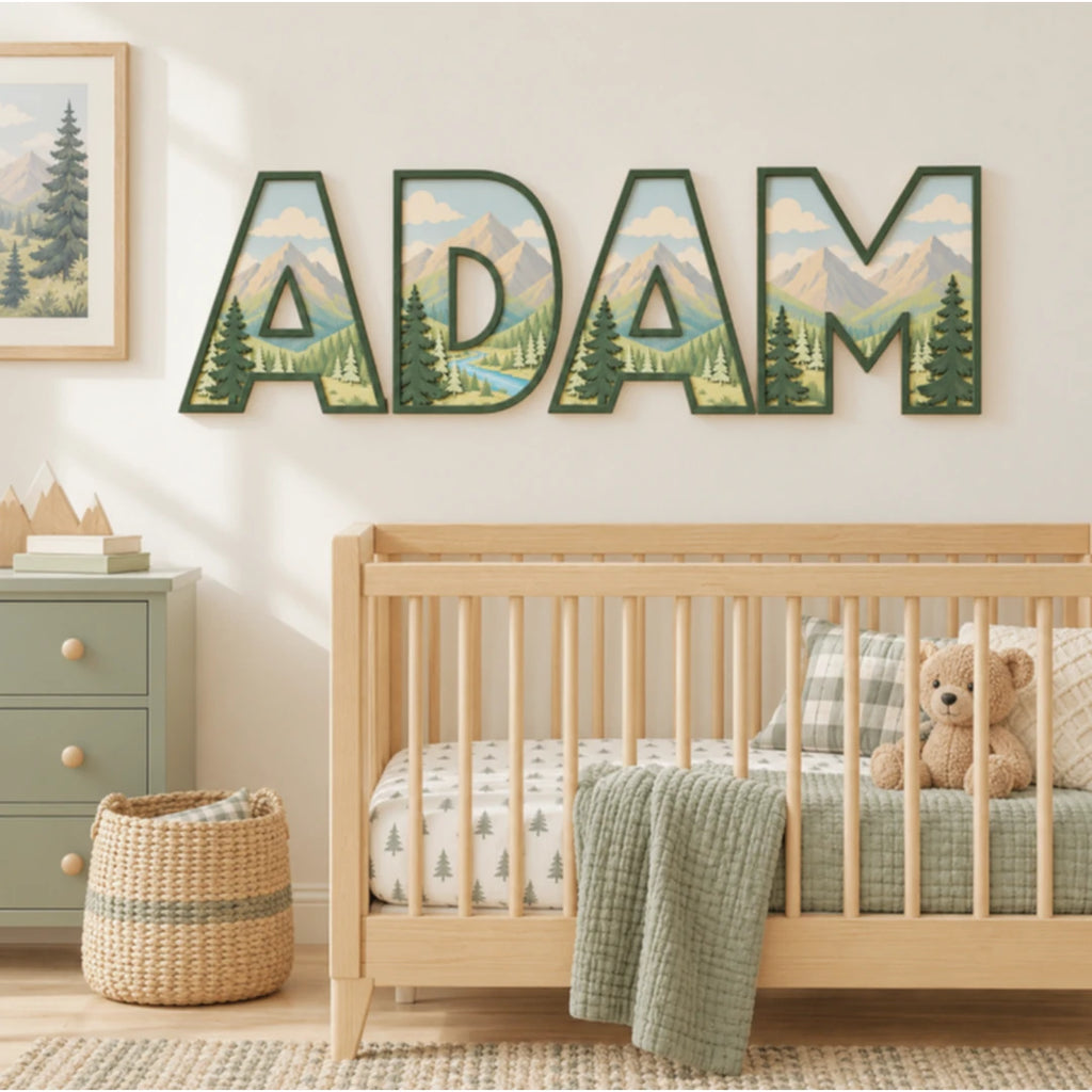ADAM personalized mountain nursery letters with layered evergreen trees above a crib