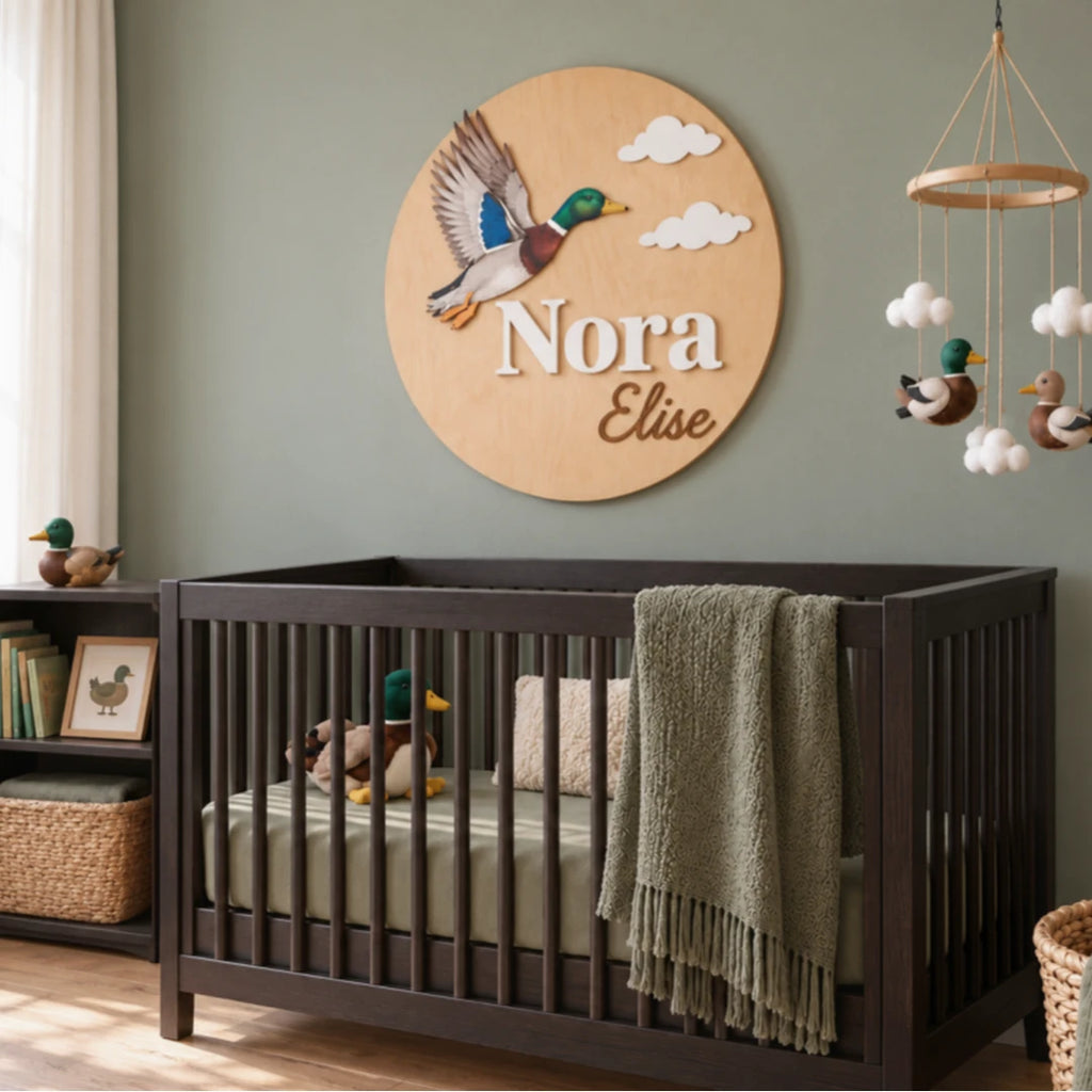 Mallard Duck nursery wall sign with personalized Nora Elise names above a crib