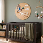 Mallard Duck nursery wall sign with personalized Nora Elise names above a crib