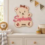Personalized teddy bear name sign displayed on a nursery wall
