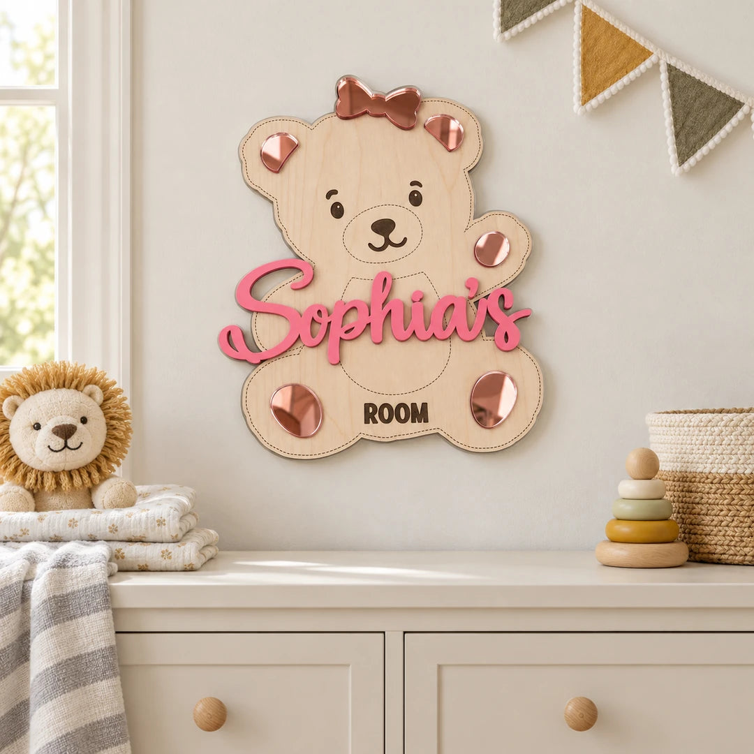 Personalized teddy bear name sign displayed on a nursery wall