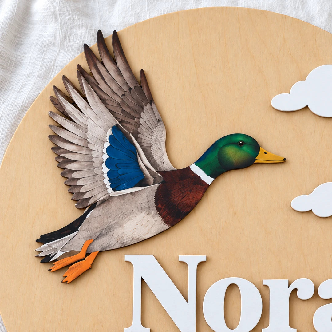 Close-up of the Mallard Duck and cloud details on the natural wood name sign