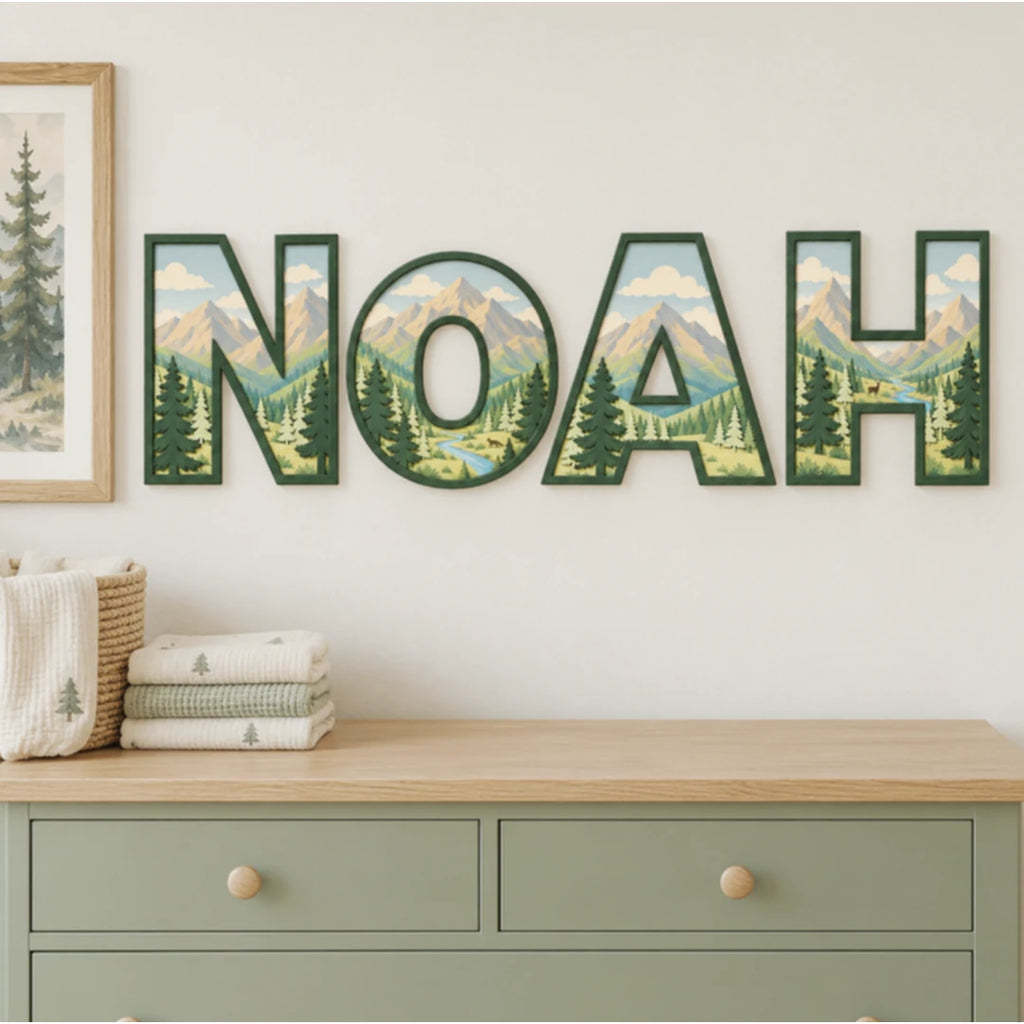 NOAH personalized mountain and evergreen tree nursery letters above a dresser