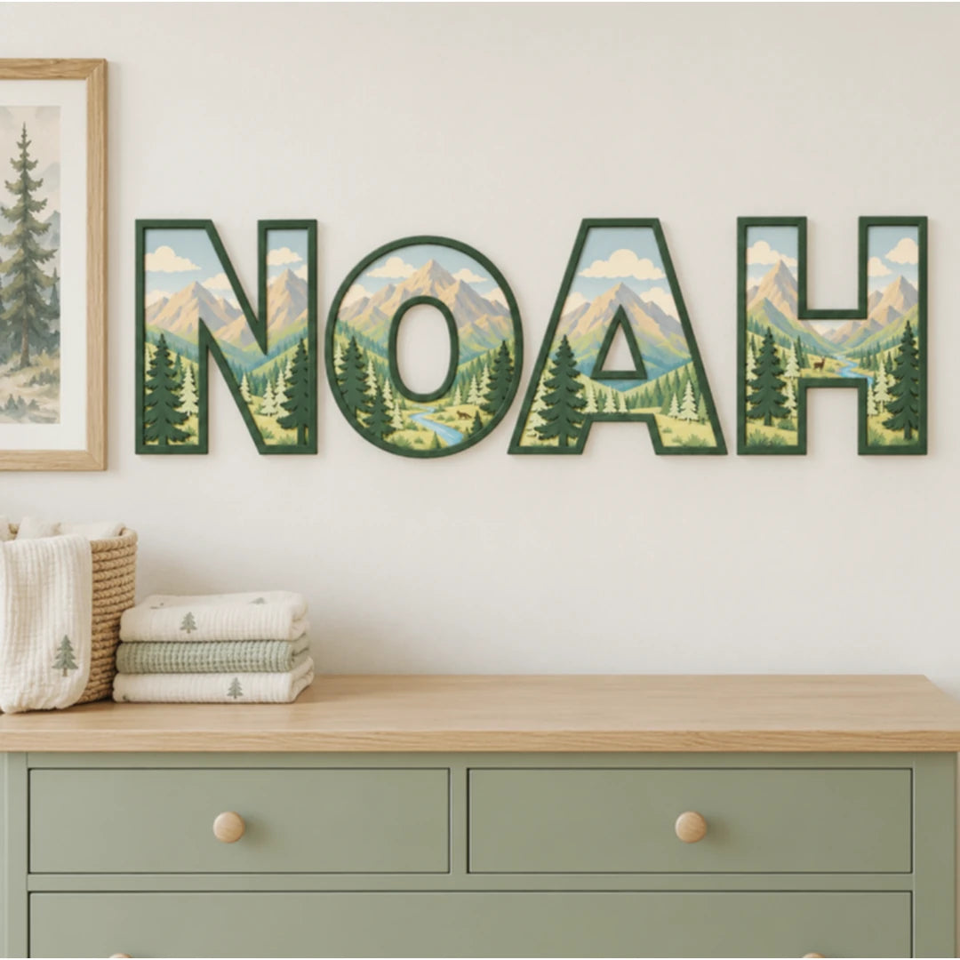 NOAH personalized mountain and evergreen tree nursery letters above a dresser